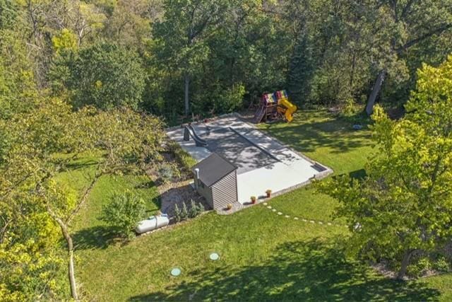 birds eye view of property with a view of trees