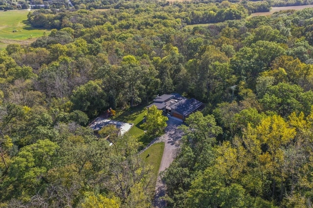 drone / aerial view with a wooded view