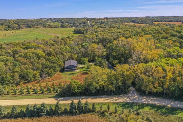 birds eye view of property featuring a view of trees