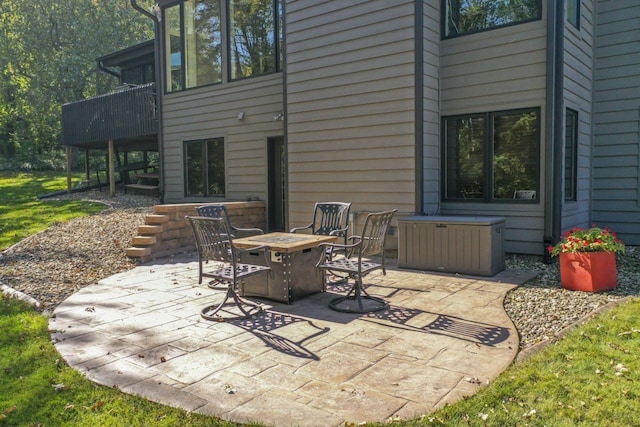 view of patio featuring stairs and an outdoor fire pit