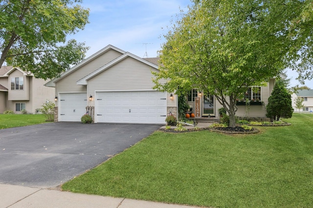 view of front of house with aphalt driveway, a front lawn, and an attached garage