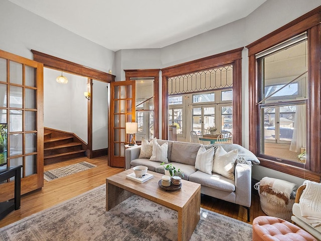 living area featuring stairway and wood finished floors