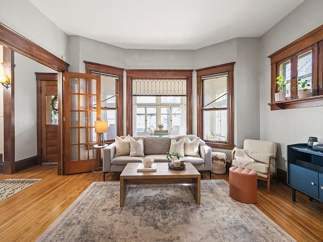 living room featuring wood finished floors and baseboards