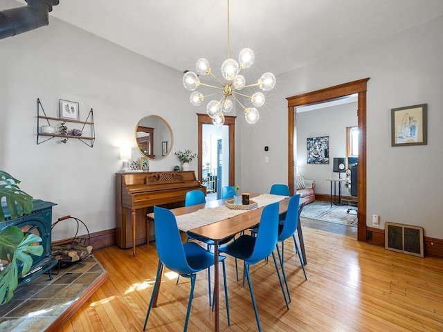 dining area featuring visible vents, baseboards, and light wood-style floors