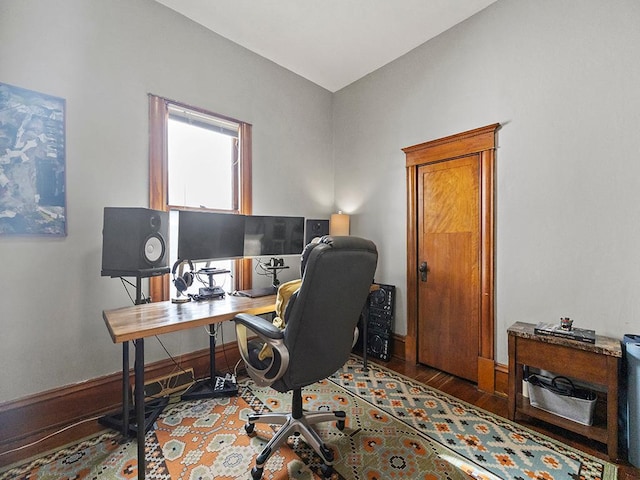 office space with baseboards and wood finished floors