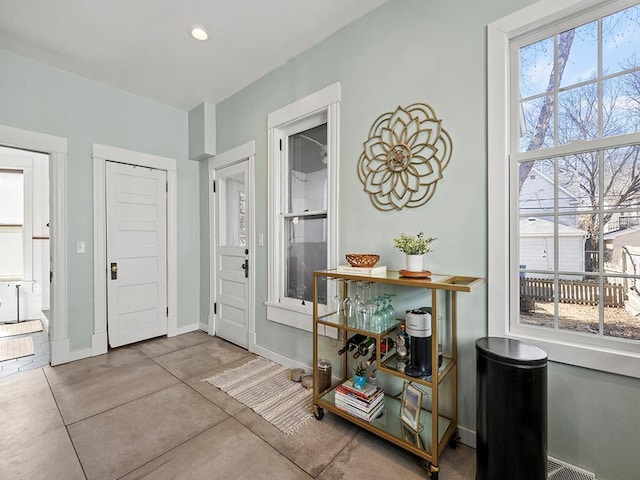 foyer entrance with recessed lighting and baseboards