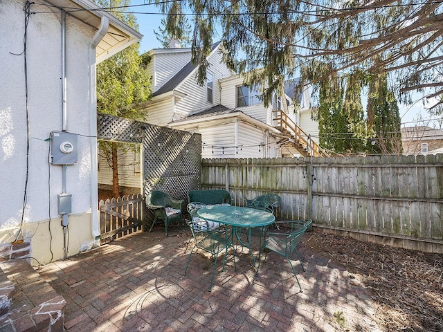 view of patio with outdoor dining space and fence