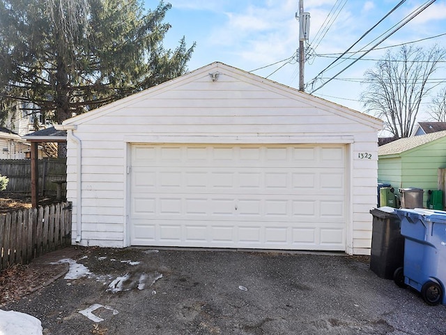 detached garage featuring fence