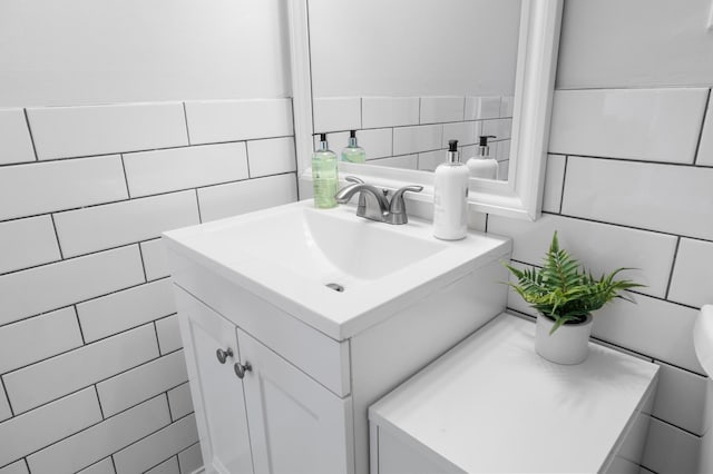 bathroom with tile walls and vanity