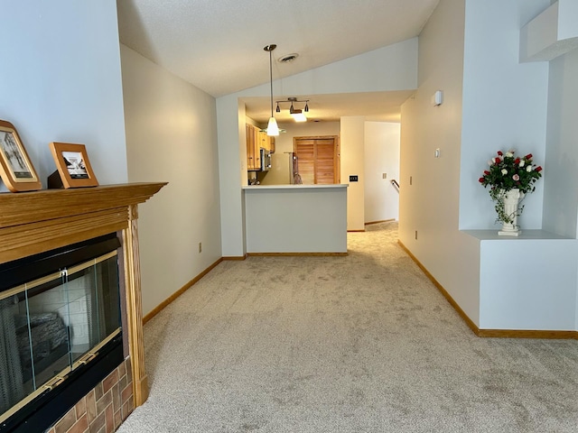 living room featuring lofted ceiling, light carpet, a glass covered fireplace, and baseboards