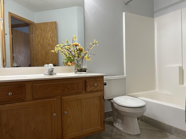 full bath featuring toilet, tub / shower combination, vanity, a textured ceiling, and tile patterned flooring