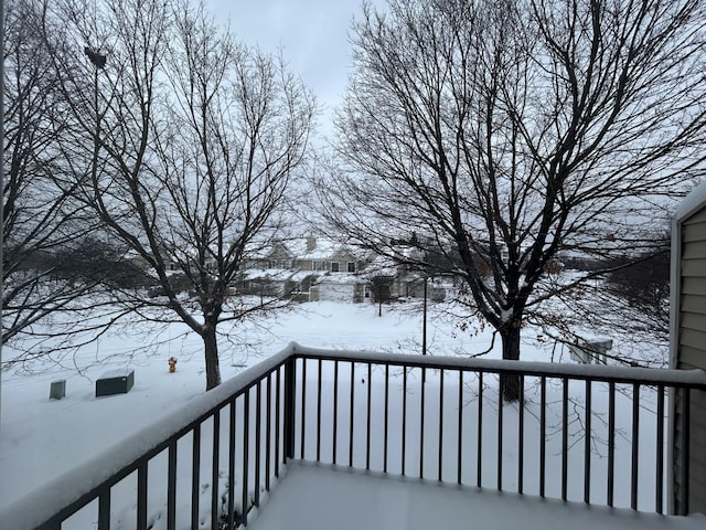 view of snow covered back of property