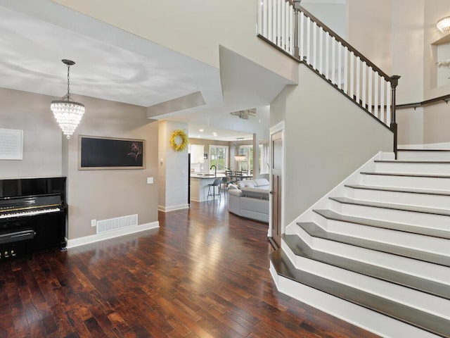 1757 Sandbar Cir, Waconia, MN 55387 - living room featuring wood-type flooring, baseboards, stairway, and a chandelier