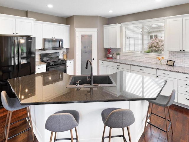 1757 Sandbar Cir, Waconia, MN 55387 - kitchen featuring black appliances, a sink, recessed lighting, backsplash, and dark wood-style floors