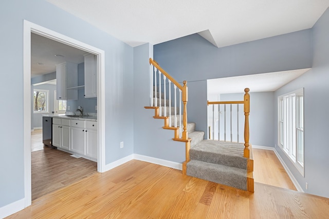 stairway featuring baseboards and wood finished floors