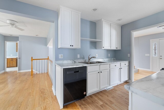 kitchen featuring light wood-type flooring, white cabinetry, dishwasher, and a sink