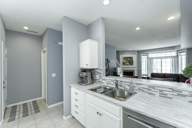 1868 Tiffany Cove Ln SW, Rochester, MN 55902 - kitchen featuring a sink, open floor plan, tasteful backsplash, baseboards, and light countertops