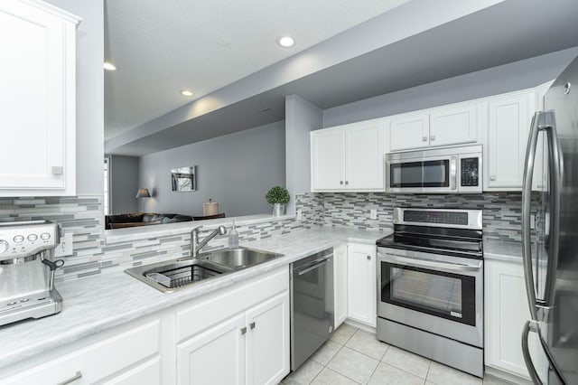 1868 Tiffany Cove Ln SW, Rochester, MN 55902 - kitchen featuring stainless steel appliances, a sink, light tile patterned floors, decorative backsplash, and recessed lighting