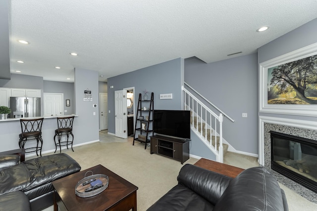 1868 Tiffany Cove Ln SW, Rochester, MN 55902 - living area with light colored carpet, stairway, a textured ceiling, recessed lighting, and baseboards