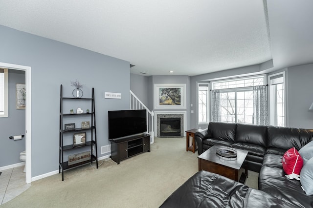 1868 Tiffany Cove Ln SW, Rochester, MN 55902 - living room with light carpet, baseboards, and a fireplace with flush hearth