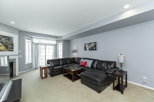 1868 Tiffany Cove Ln SW, Rochester, MN 55902 - living area with light carpet, baseboards, a textured ceiling, a tiled fireplace, and recessed lighting