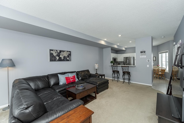 1868 Tiffany Cove Ln SW, Rochester, MN 55902 - living area featuring a textured ceiling, light carpet, baseboards, and recessed lighting