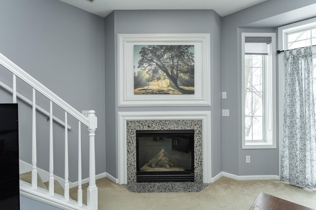 1868 Tiffany Cove Ln SW, Rochester, MN 55902 - unfurnished living room featuring carpet flooring, stairs, baseboards, and a high end fireplace