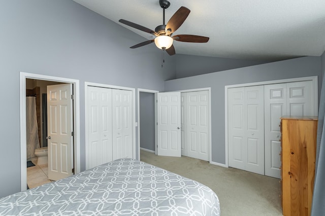 1868 Tiffany Cove Ln SW, Rochester, MN 55902 - bedroom featuring multiple closets, light carpet, connected bathroom, high vaulted ceiling, and ceiling fan