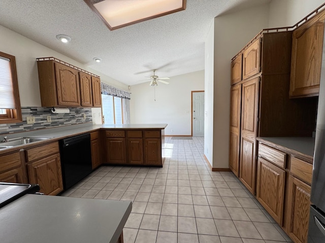 kitchen with light tile patterned floors, a peninsula, black dishwasher, vaulted ceiling, and tasteful backsplash