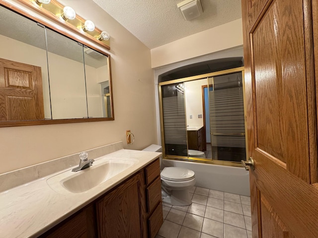 bathroom featuring toilet, tile patterned flooring, a textured ceiling, vanity, and washtub / shower combination