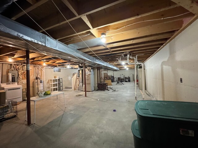 unfinished basement with washer / dryer, gas water heater, electric panel, and heating unit