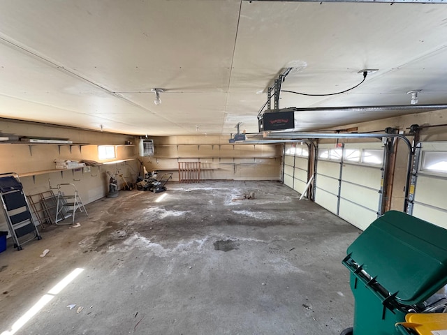 garage featuring a wall unit AC and a garage door opener