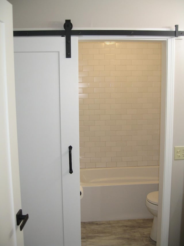 bathroom with shower / bathing tub combination and toilet