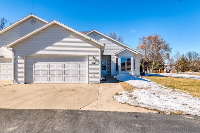 ranch-style home with driveway and an attached garage