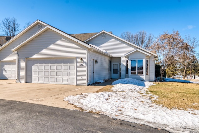 ranch-style house with a garage and driveway