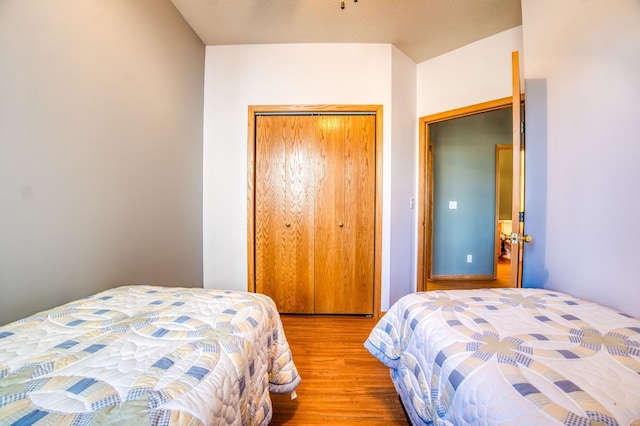 bedroom with a closet and wood finished floors