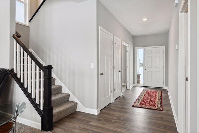 entrance foyer featuring dark wood-style floors, baseboards, and recessed lighting