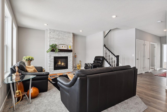 living area with stairway, a fireplace, wood finished floors, and recessed lighting