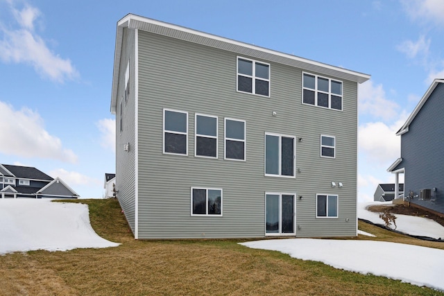 rear view of property with a yard