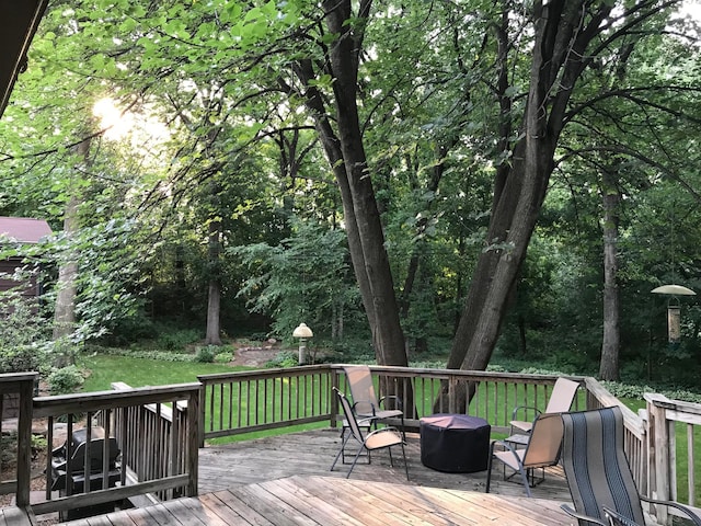 wooden terrace featuring a forest view