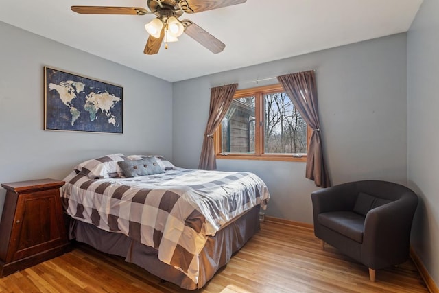 bedroom with light wood-style floors and a ceiling fan