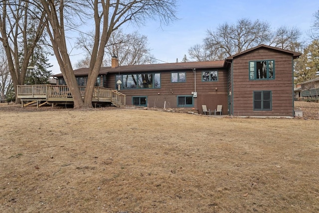 rear view of house featuring a deck and a chimney