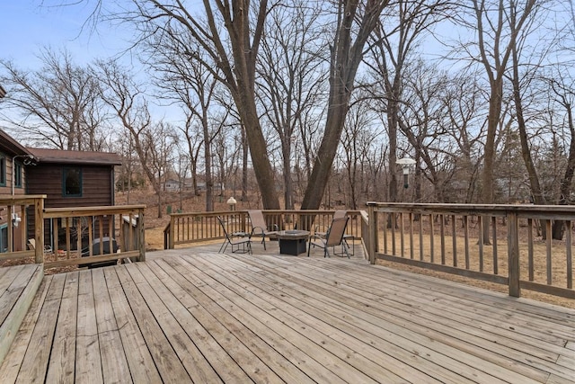 wooden terrace with an outdoor fire pit