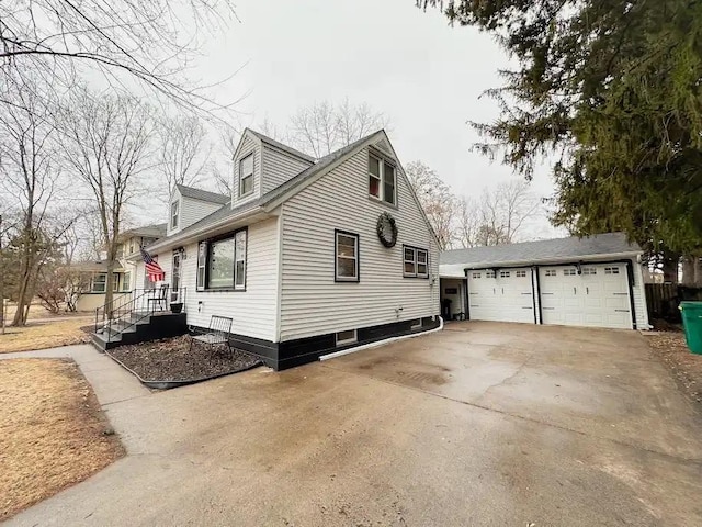 view of home's exterior featuring an outbuilding and a detached garage