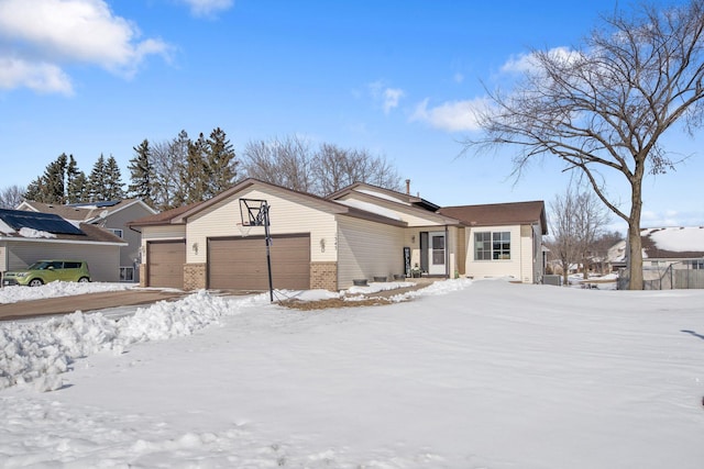 view of front of house featuring brick siding and a garage