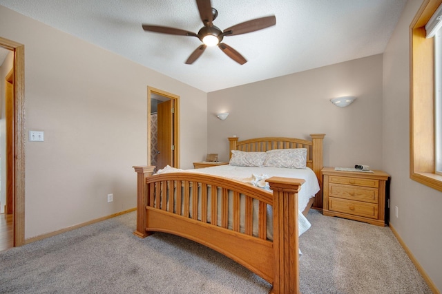 bedroom with a ceiling fan, baseboards, and carpet floors