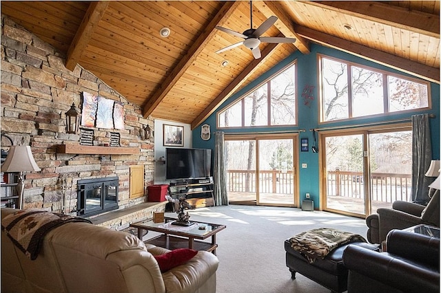 carpeted living area featuring wooden ceiling, ceiling fan, a fireplace, high vaulted ceiling, and beam ceiling