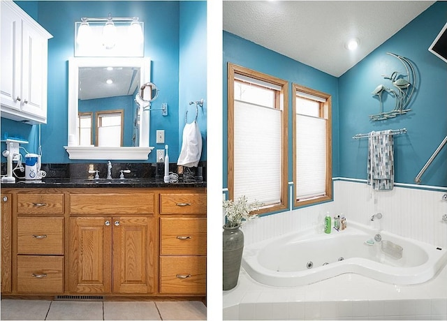 bathroom featuring a whirlpool tub, tile patterned flooring, and vanity