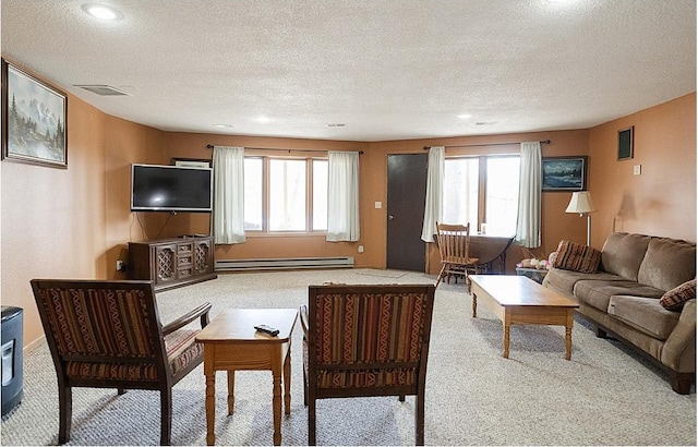 carpeted living room featuring a healthy amount of sunlight, visible vents, a baseboard heating unit, and a textured ceiling