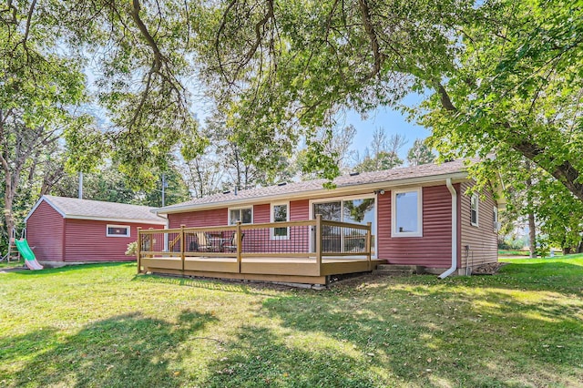 view of front facade with a deck and a front lawn